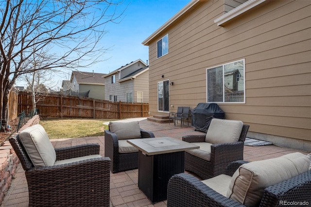 view of patio featuring area for grilling, an outdoor living space, entry steps, and a fenced backyard