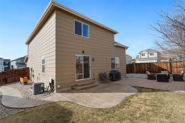 rear view of house with an outdoor living space, entry steps, central AC, a fenced backyard, and a patio