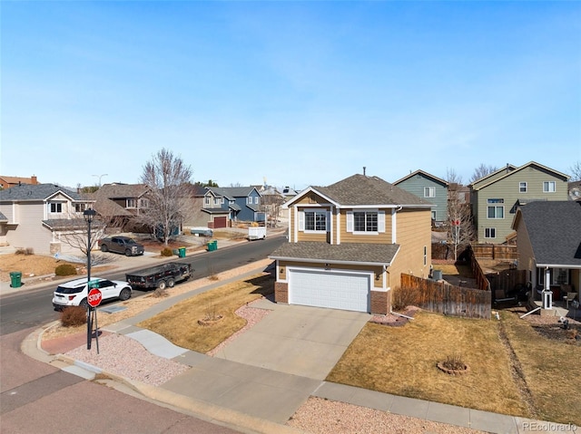 traditional home featuring driveway, fence, a residential view, a garage, and brick siding