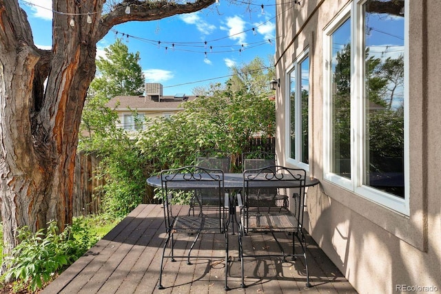 wooden deck featuring outdoor dining area and fence