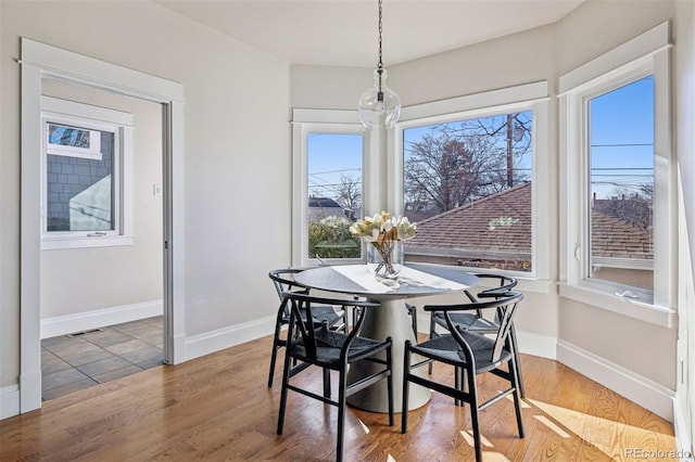 dining area featuring wood finished floors and baseboards