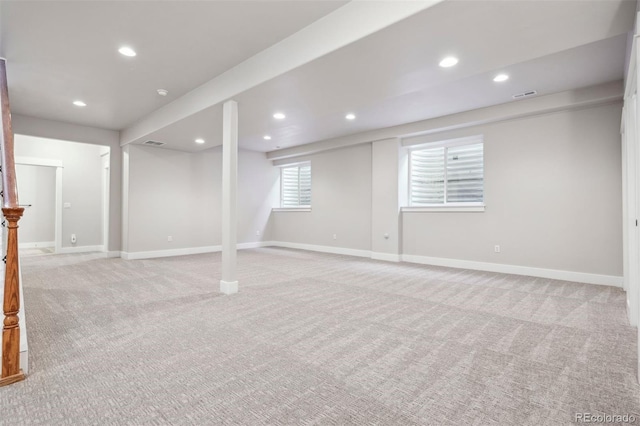 basement featuring light colored carpet, recessed lighting, and baseboards