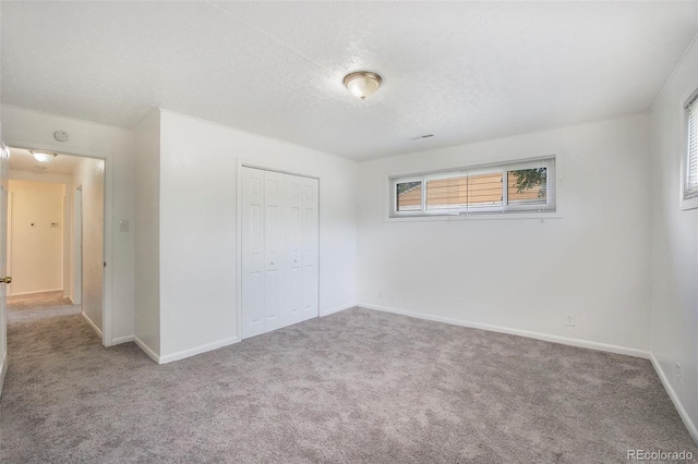 1303 Havana St, Aurora, CO 80010 - unfurnished bedroom with carpet, a closet, and a textured ceiling