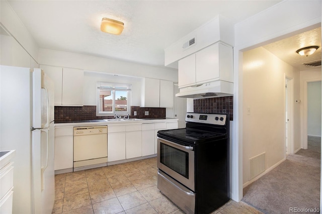 1303 Havana St, Aurora, CO 80010 - kitchen featuring white appliances, under cabinet range hood, decorative backsplash, and white cabinetry