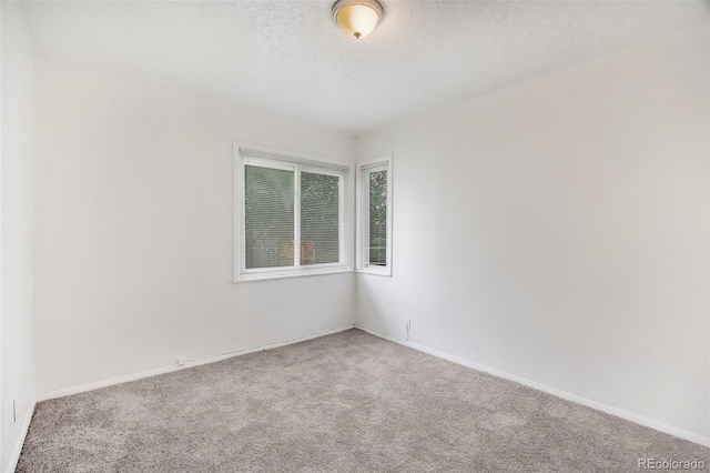 1303 Havana St, Aurora, CO 80010 - carpeted spare room with baseboards and a textured ceiling