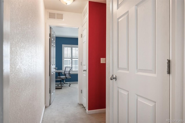 767 Roslyn St Unit 20, Denver, CO 80230 - hall with baseboards, light carpet, and visible vents