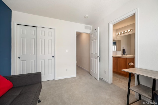 767 Roslyn St Unit 20, Denver, CO 80230 - sitting room with baseboards, visible vents, and light colored carpet