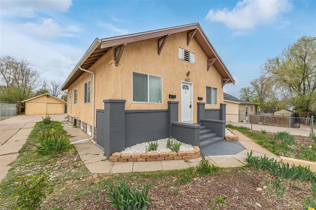 view of front facade featuring fence and stucco siding