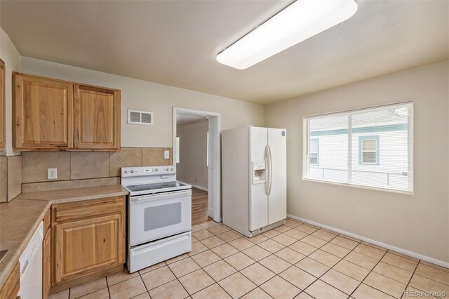 907 4th Ave And B, Unit A, Greeley, CO 80631 - kitchen featuring light tile patterned flooring, white appliances, light countertops, backsplash, and visible vents
