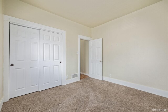 907 4th Ave And B, Unit A, Greeley, CO 80631 - unfurnished bedroom featuring a closet, baseboards, carpet flooring, and visible vents