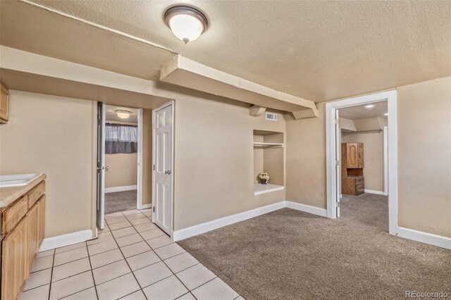907 4th Ave And B, Unit A, Greeley, CO 80631 - interior space featuring light colored carpet, a textured ceiling, visible vents, and baseboards