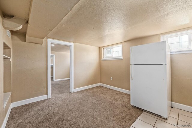 907 4th Ave And B, Unit A, Greeley, CO 80631 - basement featuring freestanding refrigerator, a textured ceiling, and a wealth of natural light