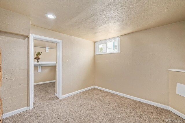 907 4th Ave And B, Unit A, Greeley, CO 80631 - below grade area featuring a textured ceiling, baseboards, and carpet