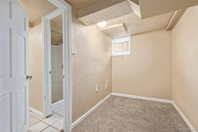 907 4th Ave And B, Unit A, Greeley, CO 80631 - basement with baseboards, a textured wall, and light colored carpet