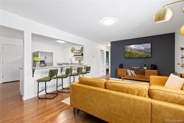 living area featuring baseboards and wood finished floors