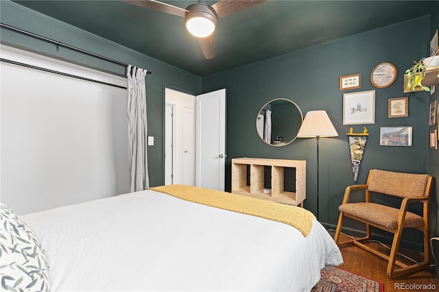 bedroom featuring ceiling fan and dark wood-style flooring