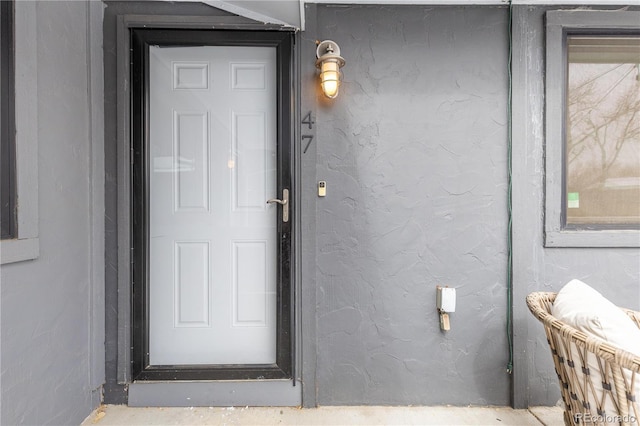 entrance to property with stucco siding