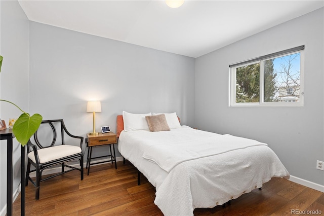 bedroom featuring baseboards and wood finished floors