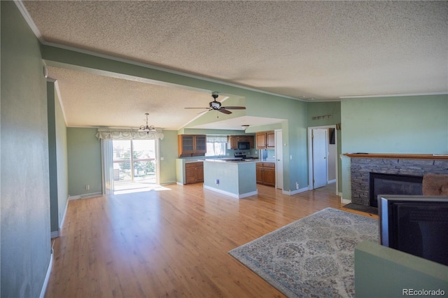 112 8th St, Hugo, CO 80821 - unfurnished living room with a textured ceiling, ornamental molding, light wood-style flooring, a fireplace, and baseboards