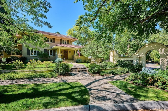 mediterranean / spanish-style house featuring a tile roof and stucco siding