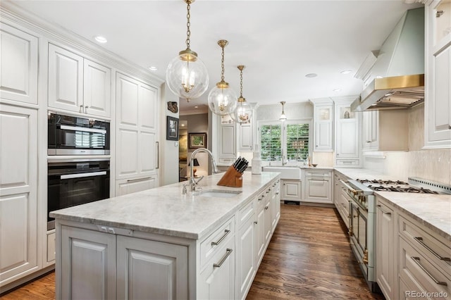 kitchen featuring premium range hood, a kitchen island with sink, stainless steel range, and white cabinets