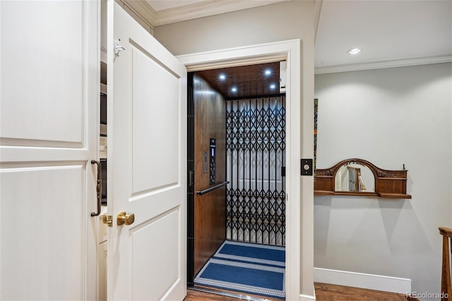 interior space with baseboards, recessed lighting, elevator, and crown molding