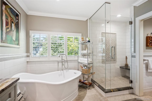 bathroom with a soaking tub, tile walls, and crown molding