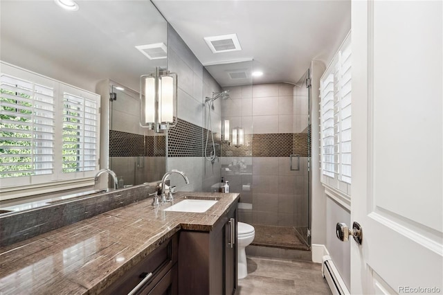 full bath with visible vents, toilet, a baseboard radiator, vanity, and a shower stall