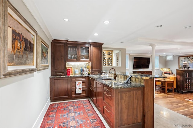 bar with recessed lighting, a sink, decorative backsplash, indoor wet bar, and ornate columns