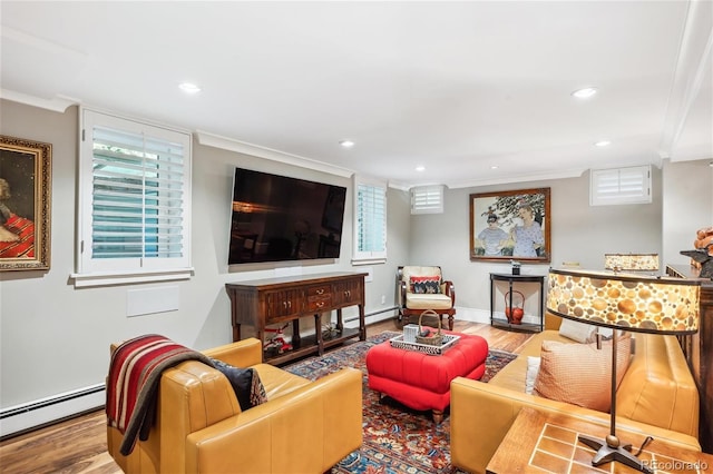 living room with a baseboard radiator, crown molding, and wood finished floors