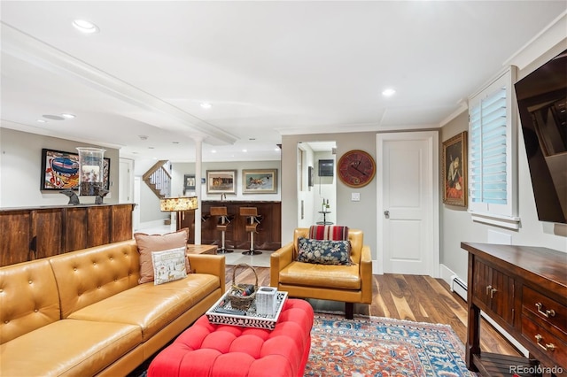 living area with light wood-style flooring, recessed lighting, a baseboard heating unit, stairway, and a bar