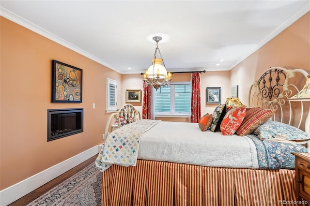 bedroom with ornamental molding, a chandelier, baseboards, and wood finished floors