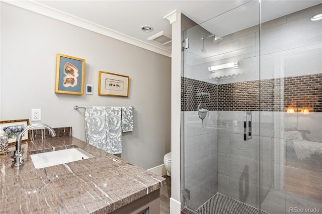 bathroom featuring visible vents, a shower stall, toilet, and vanity