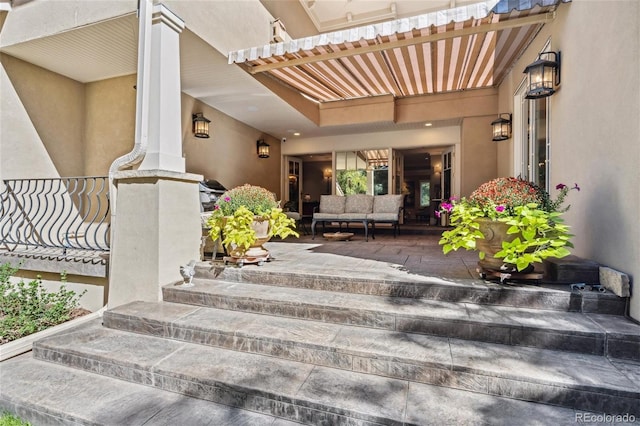 property entrance with a patio area and stucco siding