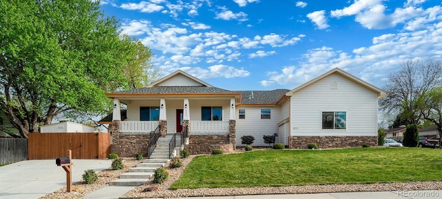 5372 W 68th Ave, Arvada, CO 80003 - view of front of home featuring covered porch, fence, stone siding, stairway, and a front lawn
