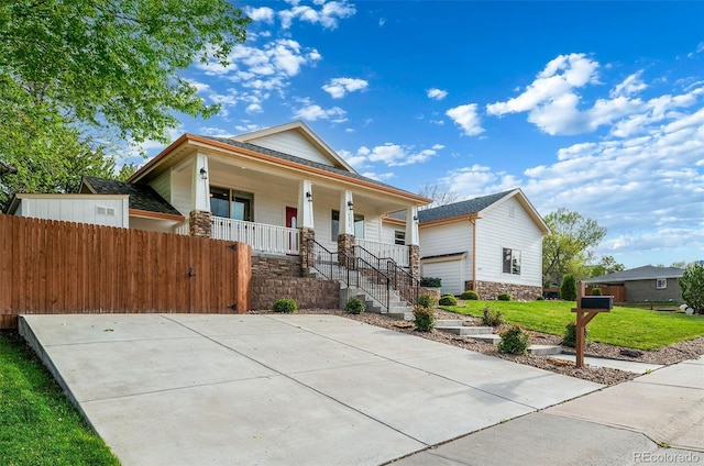 5372 W 68th Ave, Arvada, CO 80003 - view of front facade featuring a front yard, covered porch, and fence