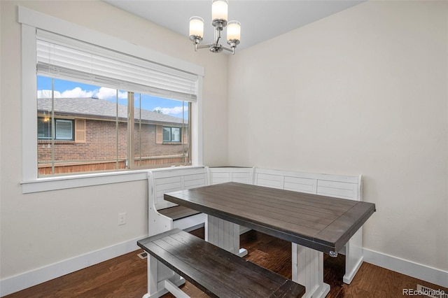 5372 W 68th Ave, Arvada, CO 80003 - dining space featuring baseboards, an inviting chandelier, and wood finished floors
