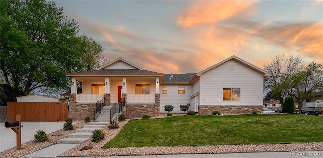 5372 W 68th Ave, Arvada, CO 80003 - view of front facade featuring a lawn, stone siding, covered porch, and stairs