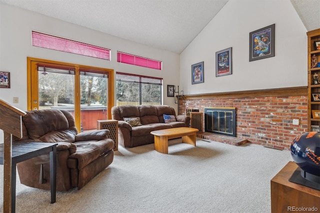 living room featuring carpet floors, a fireplace, a textured ceiling, and high vaulted ceiling