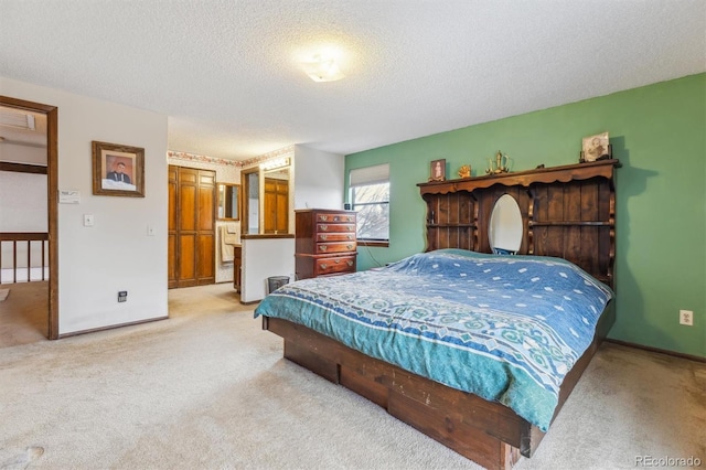 bedroom with light carpet, baseboards, and a textured ceiling