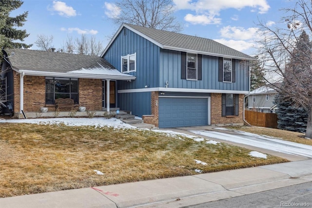 tri-level home with an attached garage, brick siding, fence, driveway, and roof with shingles