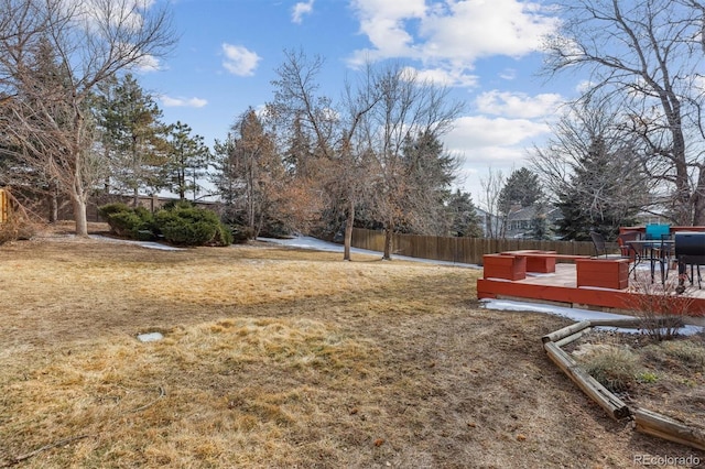 view of yard featuring fence and a wooden deck