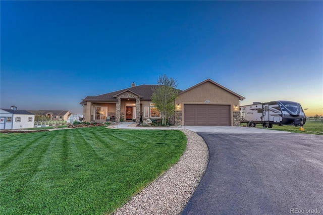 16256 Ridge Run Dr, Colorado Springs, CO 80908 - view of front of property featuring driveway, stone siding, a front lawn, an attached garage, and stucco siding
