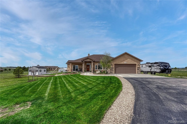 16256 Ridge Run Dr, Colorado Springs, CO 80908 - single story home featuring an attached garage, driveway, stone siding, and a front lawn