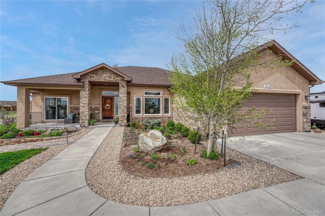 16256 Ridge Run Dr, Colorado Springs, CO 80908 - view of front of home featuring stone siding, stucco siding, driveway, an attached garage, and a porch