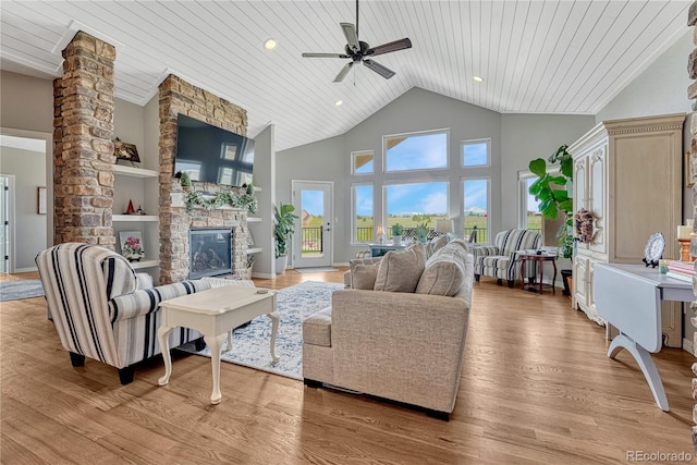 16256 Ridge Run Dr, Colorado Springs, CO 80908 - living area featuring wooden ceiling, a ceiling fan, a fireplace, light wood-style flooring, and high vaulted ceiling