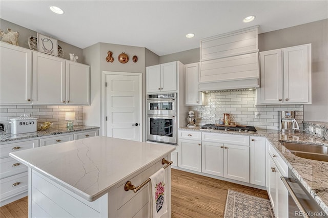 16256 Ridge Run Dr, Colorado Springs, CO 80908 - kitchen featuring appliances with stainless steel finishes, custom exhaust hood, white cabinets, and recessed lighting