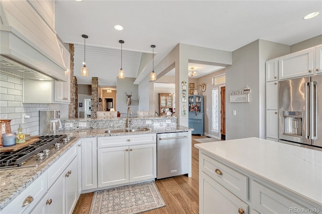 16256 Ridge Run Dr, Colorado Springs, CO 80908 - kitchen with stainless steel appliances, a sink, custom range hood, light wood finished floors, and recessed lighting
