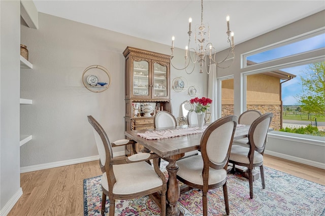 16256 Ridge Run Dr, Colorado Springs, CO 80908 - dining area with a chandelier, light wood-style floors, and baseboards