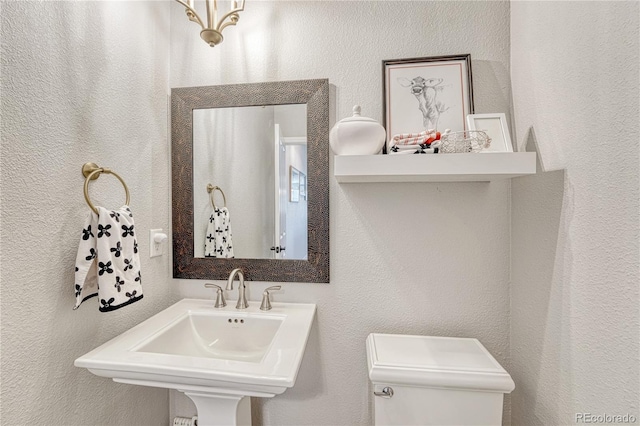 16256 Ridge Run Dr, Colorado Springs, CO 80908 - half bath featuring a textured wall, toilet, and a sink